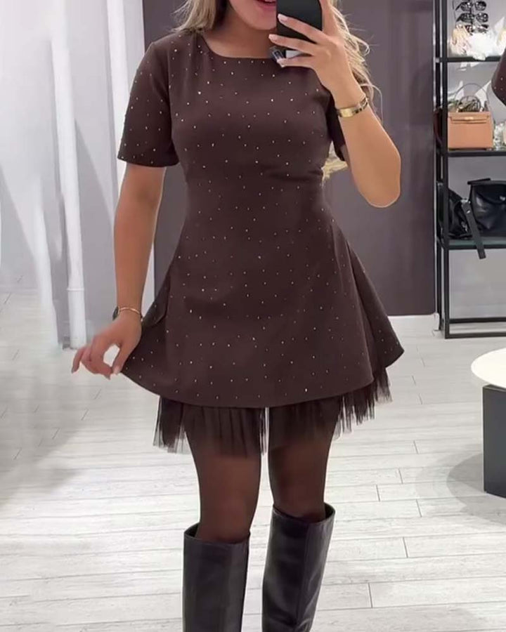 Elegant dress with a shimmering, mesh patchwork pattern