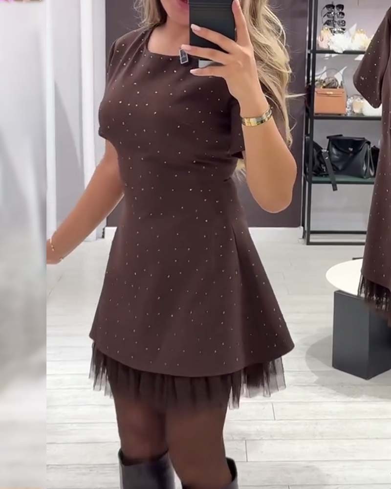 Elegant dress with a shimmering, mesh patchwork pattern