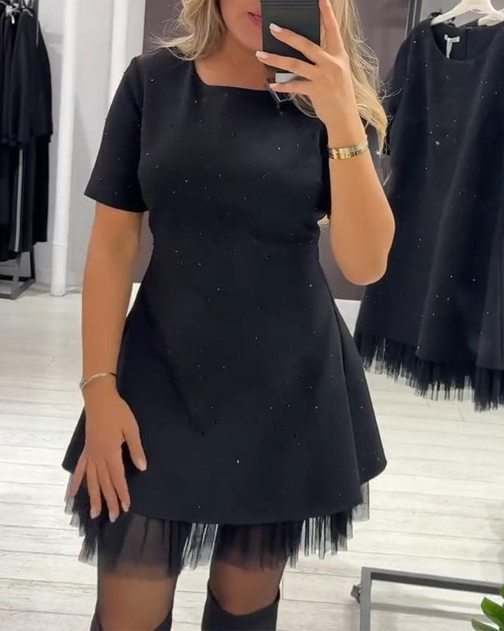 Elegant dress with a shimmering, mesh patchwork pattern