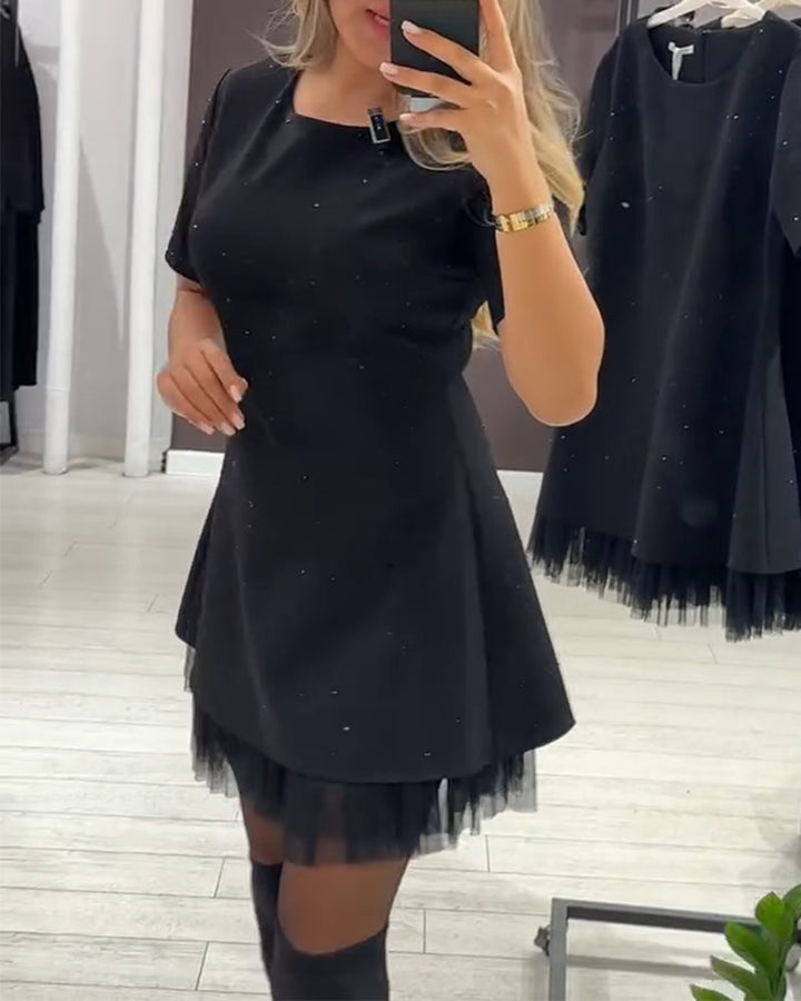 Elegant dress with a shimmering, mesh patchwork pattern